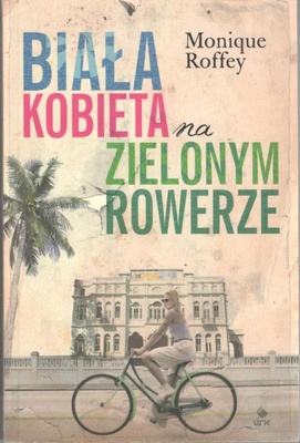 Biała kobieta na zielonym rowerze